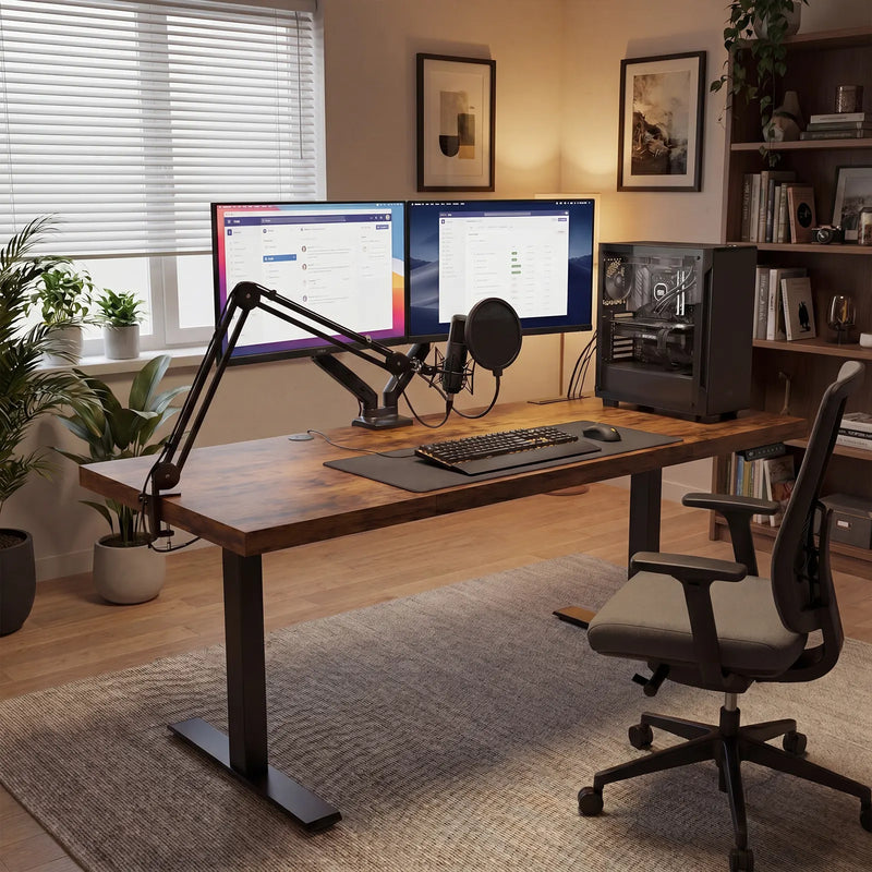 Modern OffiGo standing desk setup with dual monitors, microphone arm, PC tower, and minimalist creator studio workspace.