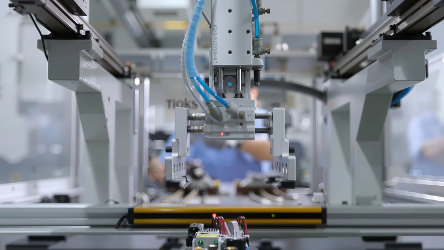 Industrial robotic arm and automated assembly equipment performing precision handling and quality control in a modern furniture manufacturing facility.