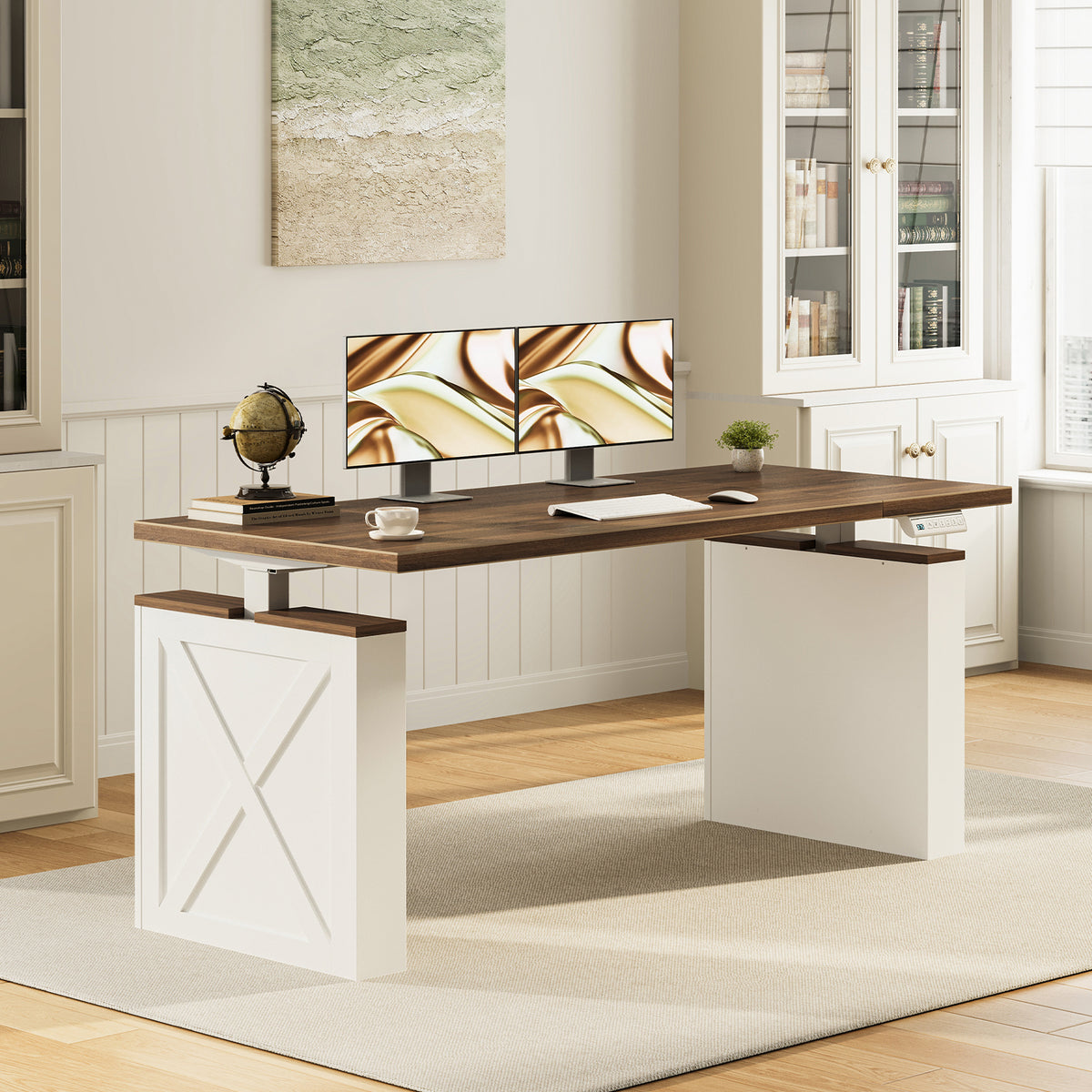 OffiGo 55-inch farmhouse standing desk with a walnut-brown desktop and white X-brace decorative legs, shown in a farmhouse home office with dual monitors beside white bookcases.