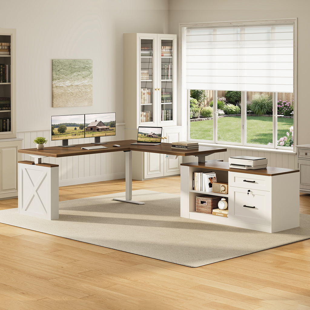 OffiGo 63-inch farmhouse L-shaped standing desk with a walnut-brown desktop, white X-brace side panel and white cabinet with open shelves and drawers, arranged in a bright farmhouse home office with dual monitors, a laptop and a printer beside white bookcases.
