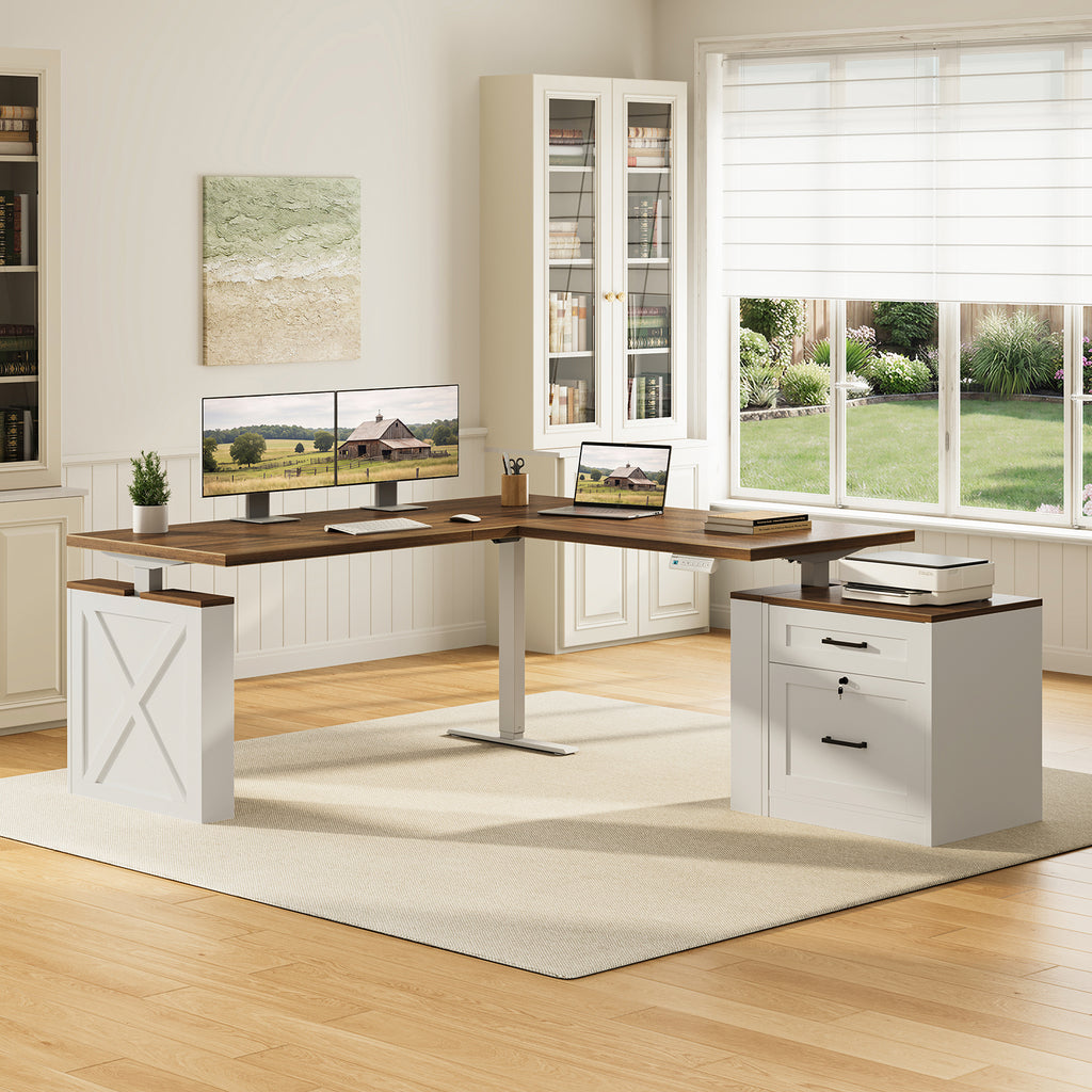OffiGo 63-inch farmhouse L-shaped standing desk with a walnut-brown desktop, white X-brace side panel and white two-drawer file cabinet, arranged in a farmhouse home office with dual monitors, a laptop and a printer beside white bookcases.