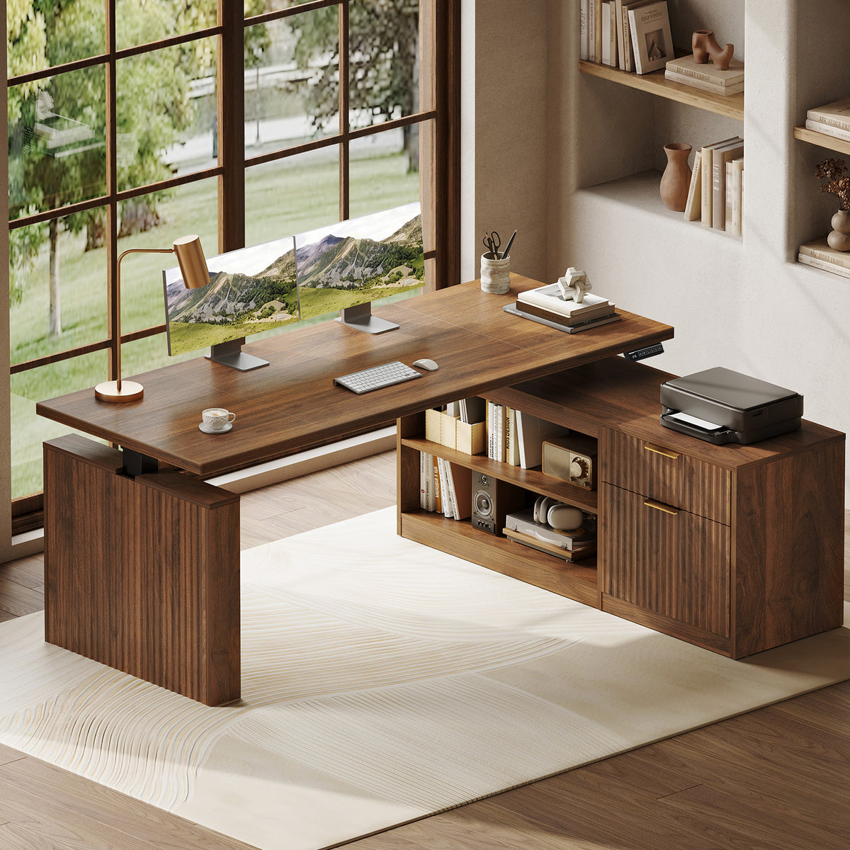 OffiGo 63-inch fluted L-shaped standing desk with a walnut-brown desktop and brown legs, with a matching fluted walnut-brown file cabinet, open shelves and drawers, shown with monitors and a printer.