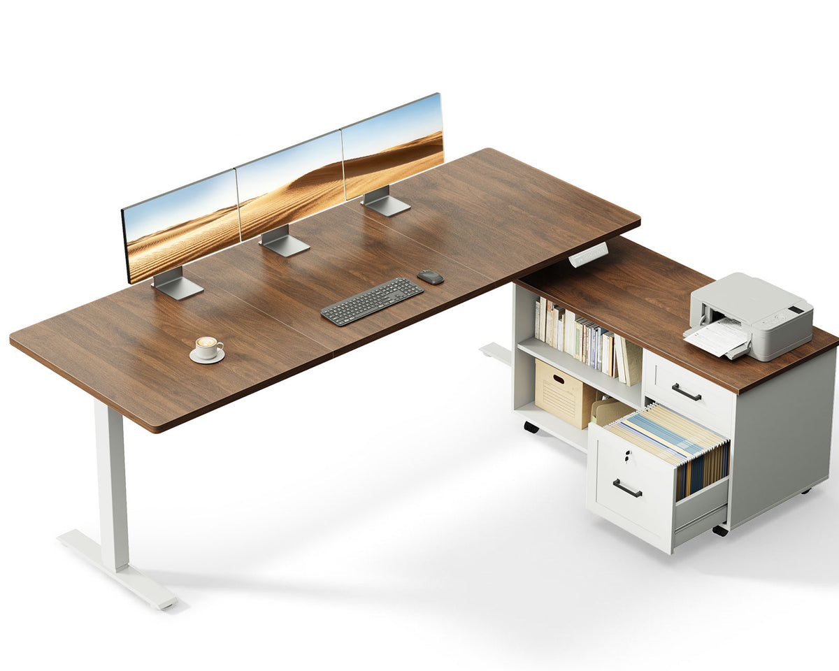 OffiGo 63-inch L-shaped standing desk with a walnut desktop, white legs and a white rolling file cabinet, shown with multiple monitors and a printer on a white background.