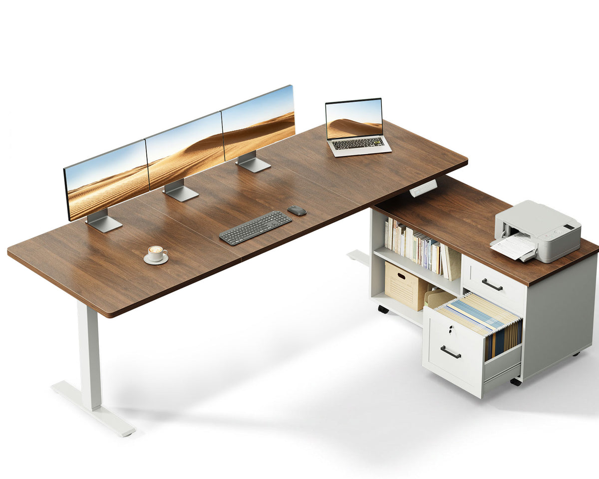 OffiGo 71-inch L-shaped standing desk with a walnut desktop, white legs and a white rolling file cabinet, shown with multiple monitors and a printer on a white background.