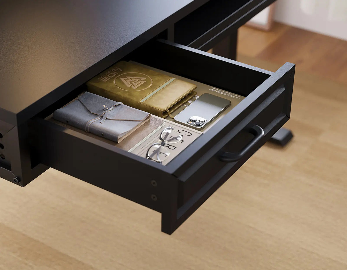 Open storage drawer beneath a black OffiGo desktop, holding notebooks, a phone, and glasses.