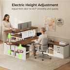 Seated and standing users at an OffiGo walnut-brown farmhouse L-shaped standing desk with white storage cabinets, illustrating electric height adjustment from 28.4 to 45.7 inches.